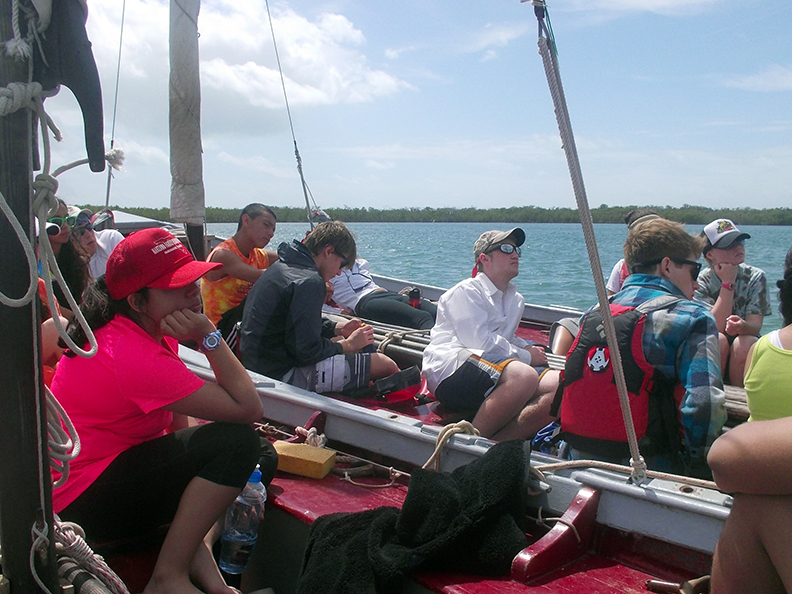 Julie Kuper (right of photo in white and blue baseball cap) and her watchmates listen to lesson while on their 2013 Spring Break Outward Bound course in Florida. 